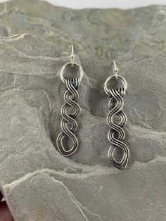 These beautiful Celtic drop earrings are truly unique.   They are made completely by hand with fine silver.  I was inspired to create these by the many different Celtic braids and knotwork  in Irish culture and felt these were a good interpretation with a modern twist. Pleasingly simple yet extraordinary, these earrings can be worn dressed up or down. They are extremely versatile and will compliment any outfit as well as get you compliments whenever you wear them.  MATERIALS•  Fine Silver •  Ear Artistic Wire Wrapped Drop Earrings, Unique Nickel-free Dangle Linear Earrings, Handmade Silver Drop Wrap Earrings, Silver Wire Wrapped Drop Earrings, Artistic Sterling Silver Teardrop Earrings, Unique Silver Plated Wire Earrings With Ear Wire, Unique Silver Plated Wire Earrings, Artistic Hypoallergenic Silver Jewelry, Silver Hypoallergenic Dangle Wrap Earrings