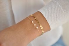 Our gift to you 10% off your first purchase. Details here - http:/eepurl.com/dpVPBzAdd a little sparkle to your wrist with our dainty sequin bracelet. It is a new classic and go to for your every occasion.....................DETAILS14 k fill or Sterling Silver.4 mm round sequins with a shiny finish.Comes with a 1" extender chain to fine tune your fit.This listing is for one sequin bracelet shown alone in pictures 3 and 8.FIND THE PERFECT FIT - MEASURE YOUR WRISTUse a tape measure to measure arou Dainty Bracelets For Bridesmaids, Dainty Chain Bracelet As Gift, Dainty Handmade Chain Bracelet For Wedding, Dainty Delicate Chain Bracelet For Gifts, Dainty Delicate Chain Bracelet As Gift, Cute Gold Party Bracelet, Dainty Adjustable Bracelets For Bridesmaid Gift, Dainty Bracelet With Adjustable Chain For Bridesmaids, Dainty Bracelet With Adjustable Chain As Bridesmaid Gift