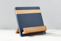 a wooden cutting board sitting on top of a white counter next to a gray wall