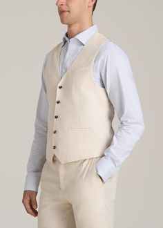 The Perfect Tall Men's Vest Elevate Your Ensemble Introducing our Stretch Linen Suit Vest, a classic wardrobe staple designed with the tall man in mind. This vest combines the timeless elegance of a tailored vest with the comfort of stretch linen, ensuring a flawless fit and enduring style. The pre-washed fabric guarantees minimal shrinkage, while the double welt pockets and button closure add a classic touch – just what you want in a tall men's jacket. Pair it with our Stretch Linen Dress Pants Elegant Cotton Nehru Jacket For Semi-formal Occasions, Elegant Semi-formal Cotton Nehru Jacket, Classic Nehru Jacket For Groom, Classic Beige Nehru Jacket For Formal Occasions, Beige Nehru Jacket For Semi-formal Occasions, Classic Semi-formal Nehru Jacket, Beige Vest With Pockets, Classic Tailored Nehru Jacket For Business, Classic Nehru Jacket With Notch Lapel For Semi-formal Occasions