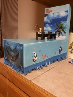 a cake made to look like a box with an image of a shark on it