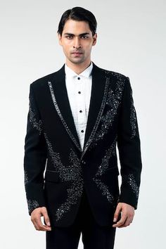 Black tuxedo jacket with hand embroidery on the front and sleeves. Paired with a pleated white shirt and a black trouser.
Components: 3
Pattern: Embroidered
Neckline: Lapel collar
Sleeve Type: Long
Fabric: Cupro, Cotton
Color: Black
Occasion: Cocktail and Reception - Aza Fashions Formal Embroidered Fitted Outerwear, Fitted Blazer For Black-tie Festive Events, Festive Fitted Blazer For Black-tie Events, Long Sleeve Tuxedo For Black-tie And Festive Events, Festive Long Sleeve Tuxedo For Black-tie Events, Festive Tailored Long Sleeve Tuxedo, Fitted Embroidered Winter Suits, Fitted Embellished Tuxedo With Long Sleeves, Festive Tuxedo For Black-tie Events