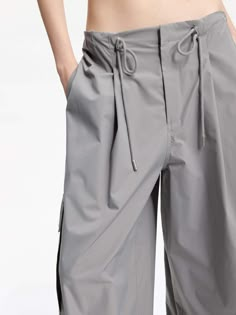 MO&Co. Women's Drawstring Detail Cargo Pants Made with breathable material, these pants feature a wide-leg cut and a drawstring waistband for a perfect fit. With multiple pockets, they are both functional and stylish. Pair them with our short cut T-shirt for a casual yet fashionable look. Features : - Wide leg cut, drawstring waistband- Concealed button, hook, and zipper closure- Multi pockets on the sides- UPF 40+ sun protection Code: MBD1PAT032The back length of size M is 106cmMATERIALS & CARE Coperni Cargo Pants, Cargo Pants Pockets, 2025 Style, Casual Cargo Pants, Drawstring Detail, Pastel Grey, Cut T Shirt, Short Cut, Cut Tshirt