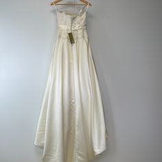 a white dress hanging on a hanger