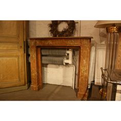 an old fireplace with a wreath on top