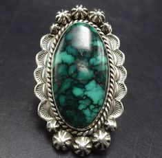 VINTAGE GREEN TURQUOISE with BLACK MATRIX STERLING SILVER  RING DESCRIPTION:  With a breathtaking specimen of green turquoise with black matrix, this ring will be a treasured addition to your collection of fine vintage Southwestern and Native American jewelry. MEASUREMENTS:  Ring face measures 1 3/4" x 1" RING SIZE: 6 3/4 WEIGHT: 16.6 grams SIGNED: E.S. STERLING: yes, stamped STERLING Vintage Handmade Green Emerald Ring, Handmade Vintage Emerald Ring, Handmade Vintage Green Emerald Ring, Vintage Green Turquoise Ring, Vintage Green Rings For Collectors, Green Oval Ring With Patina, Handmade Vintage Green Ring, Handmade Vintage Green Rings, Vintage Green Collectible Rings