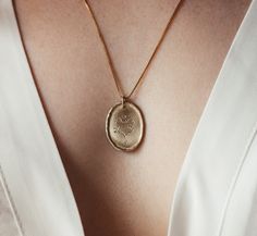 This necklace is a beautiful 14K solid gold and diamonds oval coin necklace, with a dainty heart engraving. A fine gold romantic pendant to give as a precious gift to your beloved partner. ♥ Features: ❇ Chain: ∙ 14k solid gold ∙ Gold alloy - Yellow / White / Rose Gold ∙ Length: 55 cm (21.7 inches) / 45 cm  (17.7 inches) / 42 cm (16.5 inches) ❇ Pendant: ∙ 14k solid gold ∙ Gold alloy - Yellow / White / Rose Gold ∙ Oval coin-shaped ∙ Delicate romantic heart engraving ∙ 4 grey salt-and-pepper diamon Elegant Medallion Necklace For Anniversary Gift, Elegant Oval Coin Pendant Jewelry For Anniversary, Oval Coin Pendant Jewelry For Anniversary, Elegant Oval Pendant Jewelry With Birth Flower, Delicate Engraved Jewelry With Oval Pendant, Gold Oval Necklace For Anniversary Gift, Elegant Heart Pendant Jewelry With Birth Flower Detail, Elegant Birth Flower Medallion Necklaces, 14k Gold Oval Coin Pendant Necklace