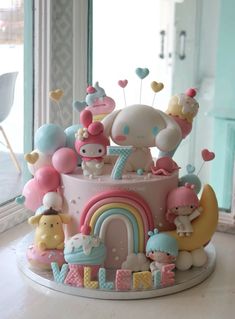 a hello kitty birthday cake with lots of decorations