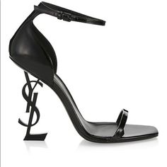 Sandals With Narrow Straps And Metal Interlocking Ysl Monogram Heel. Two Heel Heights Available. 100% Calfskin Leather Total Heel Height: 11 Cm / 4.3 Inches Leather Sole Ysl Heel In Black Metal Style Id 5576620npvv1000 Made In Italy Ysl Strappy Heels, Black Ysl Wedges, Ysl Tribute Sandals, Ysl Opyum Heel, Ysl Opyum Heel Black, Ysl Heels, Yves Saint Laurent Shoes, Metal Style, Black Metal