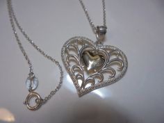 1  in. INCLUDING BAIL  sterling silver  HEART  pendant with  SOLID 10 KT SMALL CENTER HEART PENDANT   MARKED 925 / 10KT  ,   18 IN. LONG STERLING SILVER CHAIN SPRING CLASP  , great condition.  Thanks Gold Heart-shaped Jewelry Stamped 925, Gold Heart Jewelry Stamped 925, Silver Heart Necklace For Valentine's Day Formal, Silver Heart Necklace For Valentine's Day And Formal Events, Silver Hallmarked Heart Necklace For Valentine's Day, Valentine's Day Silver Heart Necklace Hallmarked, Valentine's Day Silver Hallmarked Heart Necklace, Silver Heart Pendant Necklace For Valentine's Day, Lux Lisbon