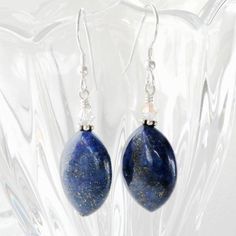 The fall season brings out our natural inclination to be fashionistas. These dark blue lapis lazuli gemstone earrings with pyrite sparkles are trendy, dangly and easy to wear with everything in your closet. Reminds me of the celestial night sky. Handmade with sterling silver earring closures. Great gift for women born in September since lapis lazuli is one of her birthstones.Earring Details:- Earrings are 1.75 inches (4.45 cm) long- Lapis lazuli gemstones are .75 inches tall and .5 inches wide ( Blue Lapis Lazuli Jewelry With Ear Wire, Elegant Lapis Lazuli Earrings With Natural Stones, Sodalite Gemstone For Jewelry Making, Lapis Lazuli Teardrop Earrings For Gifts, Lapis Lazuli Teardrop Earrings As Gift, Lapis Lazuli Teardrop Jewelry With Matching Earrings, Teardrop Lapis Lazuli Earrings For Gift, Teardrop Lapis Lazuli Jewelry With Matching Earrings, Elegant Lapis Lazuli Gemstone Earrings