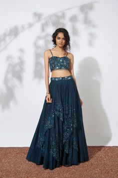 The Teal 32 Panels Lehenga and Bustier is exquisitely embroidered with intricate bead, tube, and sequin details, along with delicate ring detailing. Take your fashion game to the next level with this stunning set. Perfect for any special occasion, this outfit features intricate embroidery and stunning bead, tube, and sequin details. Plus, the delicate ring detailing adds a unique and playful touch. Get ready to turn heads and make a statement with this dazzling ensemble. Colour : TEAL Fabric : C Sequin Palazzo Saree Set For Evening, Traditional Sequin Palazzo Set For Reception, Evening Palazzo Saree Set With Sequins, Traditional Drape Skirt Set With Resham Embroidery For Reception, Traditional Palazzo Set With Sequins For Reception, Hand Embellished Sets For Diwali Party, Glamorous Organza Sets, Evening Party Wear Embroidered Choli, Embroidered Choli For Evening Party Wear