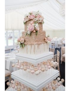 three tiered wedding cake with pink flowers on top