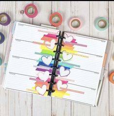 an open planner with hearts on it next to washi tapes