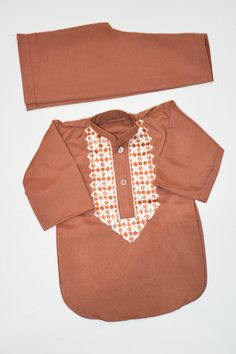 Description Colour: Dark Brown Fabric: 100% Cotton Dress Front: Embroidery  This is a handmade outfit for infant, toddler and kid boys. It includes a top and bottom with machine embroidery front. It would be an ideal outfit for occasions such as birthdays, Eid and Weddings or a perfect gift. Available in sizes:  *3-6 months *6-9 months *12-18 months (1-1.5 years old) *18-24 months (1.5-2 years old) Top / Kurta  *Breathable and easy-to-wash cotton fabric *Easy open and close clasp-buttons *No-itc Long Sleeve Cotton Sets With Multicolor Embroidery, Multicolor Embroidered Cotton Long Sleeve Sets, Long Sleeve Multicolor Embroidered Cotton Set, Brown Unstitched Suit With Dabka For Eid, Cotton Sherwani With Multicolor Embroidery, Eid Brown Unstitched Suit With Dabka Detailing, Brown Long Sleeve Unstitched Suit For Eid, Cotton Sherwani With Dabka Work For Traditional Ceremonies, Fitted Brown Sets For Eid