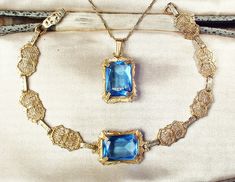 "I am SO thrilled to be offering an exquisite very rare Victorian/Edwardian circa 1930s -1940s era gold plated sapphire blue cut glass crystal pendant necklace AND/OR matching bracelet perfect for the Bride It's tough enough to find these antique filigree pieces anymore but to find pieces that are gold rather than silver, with blue stones, and then as a set is an extremely rare treat! The detailed gold plated ornate embossed pendant features a claw set rich sapphire blue high-quality cut glass c Art Deco Gold Jewelry With Intricate Design, Gold Art Deco Jewelry With Intricate Design, Art Deco Jewelry With Vintage Charm For Vintage Events, Antique Gold Jewelry For Vintage Events, Vintage Filigree Jewelry For Vintage Events, Victorian Yellow Gold Jewelry For Vintage Events, Art Deco Yellow Gold Jewelry For Vintage Events, Yellow Gold Art Deco Jewelry For Vintage Events, Antique 14k Gold Jewelry For Wedding