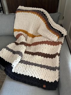 a blanket that is sitting on top of a couch