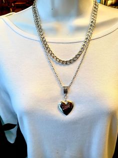 "Bold, statement heart locket pendant and  your choice of a  heavy silver chain or a long smaller link chain. Heavy silver Chain - Photo #2 - is 1/4 inch wide and measures 17\" long with a 3 inch extender. Cable link silver chain is 28\" long.  Large puffed locket heart pendant measures 1.25\" long and 1 inch wide. This beautiful locket has the word love itched on the front and it holds two photos. It slides  on either chain which makes this set very versatile." Valentine's Day Silver Charm Necklace With Chain, Valentine's Day Silver Charm Necklace, Silver Double Heart Necklace With Chain, Valentine's Day Silver Chain Necklace With Adjustable Chain, Silver Heart Pendant Chain Necklace With Chunky Chain, Valentine's Day Silver Heart Necklace With Chain, Silver Heart Necklace With Chunky Chain, Silver Metal Heart Pendant Chain Necklace, Silver Heart Pendant Chain Necklace