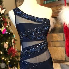 a dress on display in front of a christmas tree