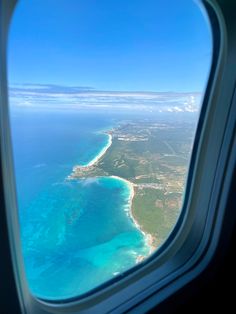 an airplane window looking out at the ocean