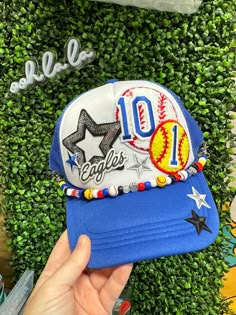 We can make you the perfect custom Sports Mom hat. You can choose your sport, colors, child's name, jersey number or initials. We add in some cute accent patches and you'll be the coolest mom at the game!  Each hat comes with a beaded brim bracelet for that extra team spirit :) Message us BEFORE ordering to be sure we have the patches you want. We offer lots of other styles. Feel free to browse our HAT SECTION and see what we have. You may just find your favorite hat. NO refunds or exchanges on custom orders. Game Day Fitted Hat For Baseball Season, Sports Fan Fitted Hat For Baseball Season, Personalized Adjustable Blue Baseball Cap, Team-colored Fitted Hat For Sports Fans, Team-colored Sports Fan Fitted Hat, Customizable Sporty Cap, Adjustable Blue Fitted Hat For Game Day, Fun Blue Customizable Hat, Adjustable Customizable Sports Fan Hat