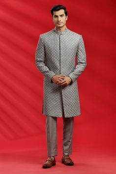 Top Details Color- GREY, Fabric - Suiting Fabric With Embroidered Bottom Details Color- Grey, Fabric -Suiting Fabric, Style - Pant Package Include :INCLUDES 1 SHERWANI,1 PANT. Turban ,Mojari And Other Accessories Are Not Sold Along With The Dress. CARE: DRY CLEAN ONLY Additional Information : - As This Sherwani/Waistcoat/Kurta Are Made As Per Orders So It Is Strictly Not Acceptable Once Get Delivered .So Kindly Choose Body Fit Size . Also We Keep 2 Inches Extra Margin In The Dress. Silver Traditional Wear With Intricate Embroidery For Eid, Silver Kurta With Zari Work For Wedding, Silver Wedding Kurta With Zari Work, Bollywood Style Silver Kurta For Wedding, Silver Wedding Kurta, Festive Silver Wedding Kurta, Silver Sets With Intricate Embroidery For Eid, Silver Traditional Wear With Chikankari Embroidery For Weddings, Silver Traditional Wear With Chikankari Embroidery