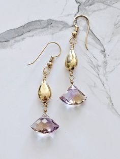 Beautiful natural Ametrine dangling from gold filled beads.  Ametrine is a combination of amethyst and citrine within one stone.  All the known ametrine had been mined so the only stones available are those already on the market - a difficult and expensive stone to find.    For me, creating jewelry is creating art I never create the same piece twice.   Ametrine combines and amplifies the benefits of chakras - the citrine (solar plexus) and crown (amethyst); citrine increases focus aided by the inspiration of amethyst. Don't lose your earrings!  Ear nuts are included with purchase. Handmade Amethyst Crystal Earrings In Gold, Gold Amethyst Long Drop Earrings, Gold Amethyst Drop Earrings, Gold Amethyst Gemstone Crystal Earrings, Gold Amethyst Crystal Earrings With Gemstone, Gold Amethyst Crystal Earrings, Gold Amethyst Earrings With Gemstone Accents, Expensive Stones, Amethyst And Citrine