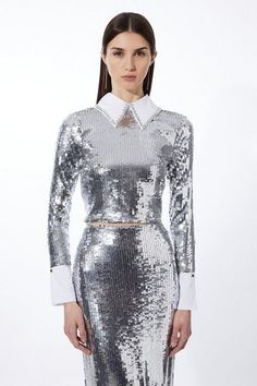 a woman in a silver sequin dress