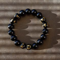 This is a mystical crystal beaded Mala bracelet, with the fusion of black onyx with the power of a Tibetan Buddhist Symbols -- 6 of the onyx beads are engraved the golden symbols! It gives the Peace, the Power, and the Protection to the person who wear it. Size(this brace let comes in 3 sizes, please select carefully):Size(this brace let comes in 3 sizes, please select carefully): -----Small: Bead diameter: 3/8 inch (10 mm) Bracelet circumference: 6 inch (15 cm) -----Medium: Bead diameter: 1/2 i Bracelet Man, Buddhist Mala, Buddhist Symbols, Buddhist Prayer, Meditation Bracelet, Prayer Bracelet, Black Onyx Bracelet, Bracelet Mens, Tibetan Buddhism