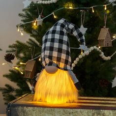 a wizard hat sitting on top of a piece of luggage in front of a christmas tree