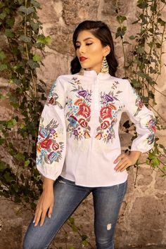 Looking perfect will be easy with this top. It is elegant and made from Fine Mexican cotton.  This blouse is embroidered with a colorful floral Mexican inspired design on the front and down the sleeves. This blouse is made in Mexico and embroidered by Mexican artisans on an Artisanal Machine. MORE BLOUSES HERE: https://www.etsy.com/es/shop/SoleiEthnic?ref=seller-platform-mcnav§ion_id=25358815 White Embroidered Button-up Top, White Button-up Top With Floral Embroidery, White Floral Embroidered Button-up Top, Bohemian Embroidered Button-up Tops, Spring Long Sleeve Blouse With Multicolor Embroidery, White Long Sleeve Embroidered Top With Floral Print, Summer Tops With Multicolor Embroidery And Buttons, White Long Sleeve Top With Floral Embroidery, Multicolor Embroidered Tops With Buttons For Summer