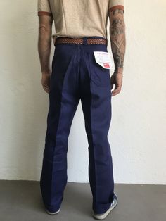 "French blue work trousers - Macober Made in France 1970s High waist pants in indigo blue sanforized cotton . Straight cut with crease. 5 button closure. Bakelite buttons. All originals. 2 side pockets, 1 buttoned back pocket. 5 belt loops. In perfet condition. New item. Deadstock With original cardbord label . Never washed. Label size: 42/12 The model usually wears a size M (40/42) and measurs 175cm - 68,8,\" Measurements (flat): Waist: 42cm - 16,5\" Hips: 54cm - 21,2\" Crotch: 33cm - 12,9\" fr Cotton Work Pants With Belt Loops, Retro Cotton Jeans For Work, Retro Cotton Pants With Standard Cut Leg, Retro Straight Leg Cargo Pants, Retro Cotton Pants With Standard Cut, Retro Work Pants With Pockets, Blue Work Pants With Belt Loops, Blue Full Length Work Pants With Belt Loops, Indigo Workwear Bottoms With Belt Loops