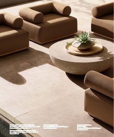 a living room filled with lots of couches next to a swimming pool on top of a cement floor