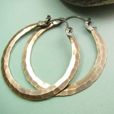 "The ultimate large bronze and sterling silver hoop earrings. Our new bronze ( also known as red brass and nugold ) Rio design, meticulously and deftly forged for a polished but rustic look. Finished with our sterling silver latch design for a secure and easy to use closure that maintains a sleek profile. A dynamic pair of handmade hammered hoops that are sure to become a favorite addition to your jewelry collection. Oxidized, brushed and polished to finish. Rio Hoops are a signature Mocahete de Small Silver Hoop Earrings, Metalsmithing Jewelry, Hammered Hoop Earrings, Mixed Metal Jewelry, Turquoise Ring Silver, Bird Earrings, Large Hoop Earrings, Sterling Silver Hoop Earrings, Sterling Silver Hoops