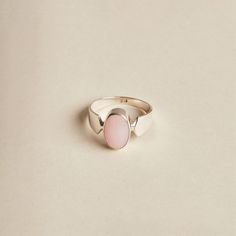 The Pink Opal is a lovely stone to wear. Its soft, baby pink oval cabochon is highlighted by the band's design. The ring is made with 925 sterling silver. The ring is available in size 6 3/4, 7.5, 9, 9.5. Dimensions: Total height: 15mm Total width: 11mm Stone height: 14mm Stone width: 10mm Stone + bezel thickness: 7mm Band width: 8mm to 3mm - Please note - * Additional photos and videos available on request * Go to 'About us' section for links to our socials and website * Only the ring from firs Adjustable Oval Opal Ring Minimalist Style, Minimalist Adjustable Oval Opal Ring, Elegant Pink Opal Oval Jewelry, Oval Pink Opal Gemstone Rings, Oval Pink Opal Jewelry Gift, Oval Pink Opal Jewelry For Gifts, Pink Oval Gemstone Jewelry, Oval Pink Opal Ring For Wedding, Classic Handmade Oval Moonstone Ring