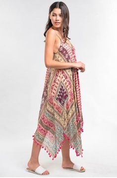 Final Sale - Get it before it's gone! For an on-point resort ensemble, reach for the Sun Kissed Pink Paisley Print Scarf Dress! Lightweight sheer dress, in hues of pink and turquoise, falls from spaghetti straps into a V-neckline into a relaxed bodice. Asymmetrical hemline with tassel trim. DETAILS & CARE Modal/Viscose. Machine wash cold. Imported. Pink V-neck Boho Dress For The Beach, Pink Sleeveless Maxi Dress Beach Cover-up, Pink V-neck Boho Dress For Beach Cover-up, Pink Printed Sundress For Beach Season, Pink V-neck Boho Dress For Beach, Printed Pink Sundress For Beach Season, Sleeveless Boho Print Dress For Beach Cover-up, Beach Boho Dress With V-neck And Paisley Print, Pink Bohemian Beach Dress For Festivals