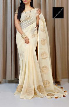 Exclusive off white Buttery soft Fine Linen by Cotton Zari woven saree with golden sequins Blouse piece . Whole body has golden zari woven motifs . Saree comes with a sequins blouse piece . Fall pico and tassels done . Can customise your blouse . Semi-stitched Off White Traditional Wear With Self Design, Beige Tissue Silk Saree With Zari Work, Beige Zari Work Tissue Silk Saree, Gold Cotton Dupatta For Navratri, Festive Off-white Traditional Wear With Self Design, Festive Gold Cotton Dupatta, White Cotton Silk Handloom Pre-draped Saree, White Semi-stitched Pre-draped Saree With Zari Weaving, Off White Chanderi Dupatta With Zari Weaving