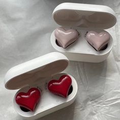 two heart shaped candles in a white box