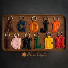 the letters are made out of leather and have different colors on each letter, including black, red, yellow, green, blue, orange