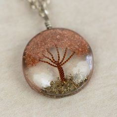 What a truly special piece the Sephira Life Tree Pendant Necklace is! A beautiful, blooming tree of life design is embedded into clear resin, which hangs as a pendant from a silver-toned chain. Makes a perfect gift for a beloved grandparent or family member, symbolizing ancestral roots. Lovingly handcrafted by artisans with Intercrafts Peru, a cooperative with more than 700 makers who come together to strengthen communities by providing access to health care, loans, advances, and training while Unique Tree Of Life Jewelry Gift, Silver Jewelry With Tree Of Life For Mom, Unique Tree Of Life Round Pendant Jewelry, Spiritual Clear Round Pendant Necklace, White Tree Of Life Jewelry Gift, Tree Of Life Pendant Necklace As Gift, Tree Of Life Round Pendant Jewelry Gift, Spiritual Tree Of Life Jewelry Gift, Spiritual Tree Of Life Jewelry As A Gift