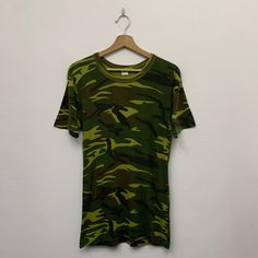 Vintage Army Camo Tshirt Size on tag : fits Small Measurement  Armpit : 17" Shoulder to bottom : 28" *Good used condition. *No holes or stains. *Overall condition is 8/10. Camouflage Graphic Print Crew Neck T-shirt, Military Style Crew Neck T-shirt For Streetwear, Green Military Style T-shirt With Crew Neck, Green Military Crew Neck T-shirt, Green Military Style Crew Neck T-shirt, Camouflage Short Sleeve T-shirt For Streetwear, Camouflage Graphic Tee For Streetwear, Military Style Cotton T-shirt With Crew Neck, Khaki Military Crew Neck Top