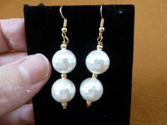 (Internal #EE473-61) This is a beautiful pair of beaded dangle earrings, two white faceted Mother of Pearl 12mm, gold brass textured spacer beads 3mm, on gold alloy French wires.Hypoallergenic french wires.This is a nice pair of earrings, for a classic look.This is exactly what you would receive.WE SHIP WORLDWIDE! Other accepted payment: Credit card (Mastercard/Visa/Discover) inquire for details. Faceted Beaded Earrings With Round Beads As Gift, Faceted Round Beaded Earrings As Gift, Faceted Round Bead Earrings As Gift, Elegant Round Beaded Earrings With Faceted Beads, Elegant Faceted Beaded Drop Earrings, White Faceted Beads Dangle Jewelry, Elegant White Earrings With Faceted Beads, Classic Pearl White Earrings With Ear Wire, Adjustable Faceted Round Bead Earrings