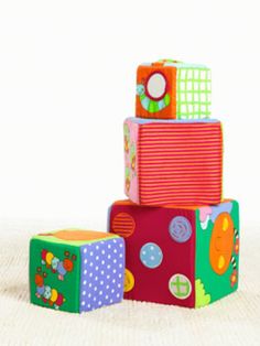 three colorful blocks stacked on top of each other in front of a white background,