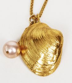 This necklace is strung with a meticulously crafted pendant in the shape of a clam shell, exactly like something you'd find on sunny shores. It can be worn alone or layered for the perfect beach or summer look. DESIGN Handmade in New York. Choose from 14kt yellow gold over brass, sterling silver or edgy gunmetal. LET'S GET PERSONAL Kick up the notch on your looks! With your simple and elegant look, you can add one of our handmade bags and personalize with your necklace. We sell everything separa Clam Necklace, Shell Charm Necklace, Necklace With Pearl, Sell Everything, Necklace Dress, Stylish Necklace, Clam Shell, Pink Pearl, Summer Look