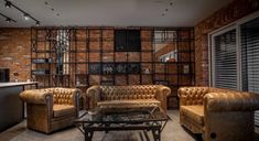 a living room filled with brown leather furniture