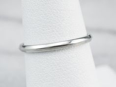 This simple white gold band is so versatile! Wear it as a wedding ring, create a ring stack, or wear it alone for a chic minimalist look. A nice detail is the knife edge profile that creates a subtle play of light! Metal: 18K White Gold Width of Band: 1.8 mm Height off Finger: 1.3 mm Ring Size: 6.75 Marks: "18K JABEL" Stamped on the inside band Minimalist Formal Bands With Smooth Bezel, Minimalist Round Band Platinum Jewelry, Minimalist White Gold Bands For Promise Ring, Minimalist Bands With Smooth Bezel For Formal Occasions, Minimalist Platinum Round Band Jewelry, Minimalist Platinum Round Band Wedding Ring, Minimalist Platinum Jewelry With Round Band, Minimalist Stackable Rings With Polished Edges For Formal Events, Minimalist Stackable Rings With Polished Edges For Anniversary