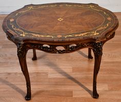 an ornately decorated wooden table on the floor