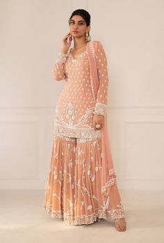 Editor's Note Featuring Peach Pink Embroidered Shirt & Gharara Set With Dupatta Fabric: Silk, Chiffon Color: Peach Pink  Embroidery Details: Zardozi Hand Embroidery Care: Dry Clean Only... Peach Indian Outfit, Pink Gharara, Traditional Dresses Indian, Peach Color Dress, Punjabi Suit Boutique, Sharara Designs, Embroidered Sharara, Sharara Suits, Desi Outfits