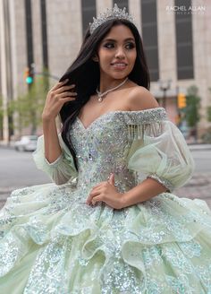 Light up the room in this beaded applique long off shoulder puff sleeve dress with A-line skirt by Rachel Allan RQ3128. Discover elegance and grace in this tulle ballgown. This romantic ballgown radiates with sophistication and is sure to leave a lasting impression. The off-the-shoulder neckline is hand beaded with applique and fringed detailing, adding a regal look to the entire silhouette. Detachable tulle sleeves provide a subtle vintage touch and a lace-up back offers the ultimate fit. As yo Off Shoulder Puff Sleeve Dress, Detachable Tulle Sleeves, Quinceanera Accessories, Off Shoulder Puff Sleeve, Tulle Ballgown, Mary's Bridal, Shoulder Puff Sleeve, Prom Dress Plus Size, Tulle Sleeves