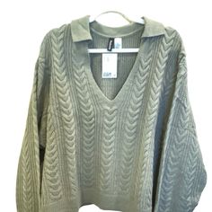 Nwt. Adorable V-Neck Cable Knit Sweater With Collar. Solid Color In Khaki Green. Ribbed Sleeves And Hem. Dropped Shoulders. Regular Length. Fit: Relaxed Fit Content: 100% Acrylic This Sweater Was Only On A Hanger For Photo Purposes Only. This Item Comes From A Smoke Free Home Same Or Next Day Shipping Except On Sundays And Holidays Thank You For Looking!!! H&m Knit V-neck Top, H&m Knit Tops For Fall, Fall Knit Tops By H&m, Casual Oversized Sweater By H&m, H&m Casual Oversized Sweater, Oversized H&m Winter Tops, Green Cable Knit V-neck Sweater, Green V-neck Cable Knit Sweater, H&m Knitted Long Sleeve Tops